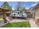 A view of the RV parking pad with a camper in the backyard of the property at 11896 W 107Th Ave, Westminster, CO 80021