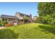 Large, grassy backyard with a covered patio and an additional seating area for entertaining and relaxation at 5988 E Jamison Ln, Centennial, CO 80112