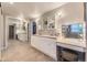 Bright bathroom with double sinks, a vanity area, and ample storage in the white cabinetry at 5988 E Jamison Ln, Centennial, CO 80112