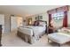 Comfortable bedroom with patterned bedding, bedside tables, and soft natural light at 5988 E Jamison Ln, Centennial, CO 80112