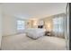 Spacious bedroom with plush carpet, large windows, and minimalist decor at 5988 E Jamison Ln, Centennial, CO 80112