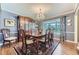 Elegant dining room with a wood table set and a decorative rug, illuminated by a crystal chandelier at 5988 E Jamison Ln, Centennial, CO 80112