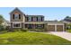 Charming two-story home featuring a well-manicured front lawn, brick accents, and a two-car garage at 5988 E Jamison Ln, Centennial, CO 80112