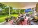 Inviting covered patio with comfortable seating and a fire pit, surrounded by lush landscaping and greenery at 5988 E Jamison Ln, Centennial, CO 80112
