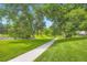 Enjoy the serene walking path through a lush green park with mature trees and natural landscaping at 5988 E Jamison Ln, Centennial, CO 80112