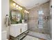 Modern bathroom with walk-in shower and updated vanity with brushed gold hardware at 3895 Chimayo Rd, Littleton, CO 80123