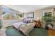 Bright bedroom featuring large windows, hardwood floors, and calming decor at 3895 Chimayo Rd, Littleton, CO 80123