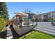 Multi-level deck with comfortable seating, lush landscaping, and easy access to the lawn at 3895 Chimayo Rd, Littleton, CO 80123