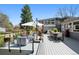Expansive deck with modern outdoor furniture, dining area, and views of the landscaped backyard at 3895 Chimayo Rd, Littleton, CO 80123
