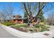 Striking brick home with modern architecture, mature landscaping, and a welcoming front yard at 3895 Chimayo Rd, Littleton, CO 80123