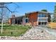Charming brick home featuring a unique architectural style and well-maintained front lawn at 3895 Chimayo Rd, Littleton, CO 80123