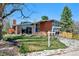 Modern brick home with sleek lines, large windows, and a beautifully landscaped front yard at 3895 Chimayo Rd, Littleton, CO 80123