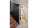 Hallway with brick stairs, modern stacked washer and dryer and a partial view of the bathroom at 3895 Chimayo Rd, Littleton, CO 80123