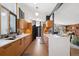 Spacious kitchen featuring custom cabinets, white countertops, stainless appliances, and a view to the living room at 3895 Chimayo Rd, Littleton, CO 80123