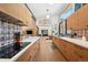 The updated kitchen offers lots of counter space, wood cabinetry, modern appliances, and an open view into the dining area at 3895 Chimayo Rd, Littleton, CO 80123
