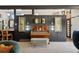 Stylish living area with a vintage piano, modern artwork, and an open view to the kitchen at 3895 Chimayo Rd, Littleton, CO 80123