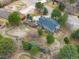 Aerial view of a home with a large yard, mature trees, and a fenced perimeter at 8165 Tempest Ridge Way, Parker, CO 80134