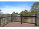 View from the wood decked porch with black aluminum railing and tree views at 8165 Tempest Ridge Way, Parker, CO 80134