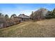 Spacious backyard with mature trees, a wooden fence, and a charming exterior at 8165 Tempest Ridge Way, Parker, CO 80134