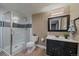 Updated bathroom featuring a modern shower with glass door, a vanity, and tile flooring at 8165 Tempest Ridge Way, Parker, CO 80134