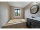 Bathroom featuring soaking tub, vanity, and mirror at 8165 Tempest Ridge Way, Parker, CO 80134