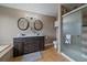 Bathroom featuring double sinks, walk-in shower, and modern fixtures at 8165 Tempest Ridge Way, Parker, CO 80134
