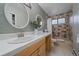 Updated bathroom with double sink vanity and tiled tub/shower at 8165 Tempest Ridge Way, Parker, CO 80134