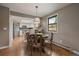 Cozy dining area featuring hardwood floors, round table, and a kitchen view at 8165 Tempest Ridge Way, Parker, CO 80134