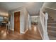 Inviting entryway with hardwood floors, paneled wood door, and staircase leading to the upper level at 8165 Tempest Ridge Way, Parker, CO 80134