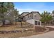 Two story home on a hill with stone accents, multiple windows, and a two-car garage at 8165 Tempest Ridge Way, Parker, CO 80134