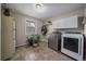 Functional laundry room with modern washer and dryer, plus storage cabinets at 8165 Tempest Ridge Way, Parker, CO 80134