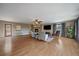 Open living room features hardwood floors, a cozy fireplace, and abundant natural light at 8165 Tempest Ridge Way, Parker, CO 80134