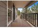 Cozy front porch featuring wood flooring, a welcome mat, and a view of the surrounding landscape at 8165 Tempest Ridge Way, Parker, CO 80134