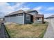 Lush backyard featuring a modern outdoor kitchen with pergola and a well-maintained lawn at 8852 Farmdale St, Firestone, CO 80504