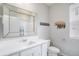 A bathroom features a vanity, a toilet, a shower over tub, and a mirror at 8852 Farmdale St, Firestone, CO 80504