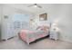 This bedroom features a cozy bed, ceiling fan, window, and light colored carpet at 8852 Farmdale St, Firestone, CO 80504