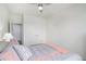 Well-lit bedroom with a queen bed, ceiling fan and neutral colors at 8852 Farmdale St, Firestone, CO 80504
