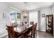 Formal dining room featuring a wood table and chairs, a sliding glass door and decorative light fixture at 8852 Farmdale St, Firestone, CO 80504