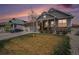 Charming home with stone accents, inviting front porch, and manicured lawn at 8852 Farmdale St, Firestone, CO 80504