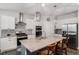 Stylish kitchen featuring white cabinets, granite countertops, and stainless-steel appliances at 8852 Farmdale St, Firestone, CO 80504