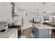 Well-lit kitchen featuring stainless steel appliances, granite countertops, grey subway tiling and light wood floors at 8852 Farmdale St, Firestone, CO 80504
