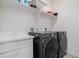 This laundry room includes modern washer and dryer units with counter space at 8852 Farmdale St, Firestone, CO 80504