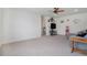 This living room features a couch, a tv, a ceiling fan, and a carpeted floor at 8852 Farmdale St, Firestone, CO 80504