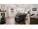 Open-concept living room featuring hardwood floors and a view into the kitchen at 8852 Farmdale St, Firestone, CO 80504