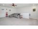 Spacious living room featuring carpeted floors, a sofa, and a ceiling fan at 8852 Farmdale St, Firestone, CO 80504