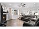 Bright living room with fireplace and hardwood floors flowing into the dining area at 8852 Farmdale St, Firestone, CO 80504