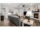 Spacious living room with a fireplace, hardwood floors, and ample seating at 8852 Farmdale St, Firestone, CO 80504