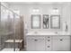 Bright primary bathroom showcasing a double vanity, framed mirrors, and walk-in shower with bench seating at 8852 Farmdale St, Firestone, CO 80504
