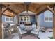 Beautiful outdoor kitchen under a wooden pergola, complete with a built-in grill and fire pit at 8852 Farmdale St, Firestone, CO 80504