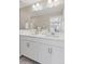 Bathroom featuring a double sink vanity with white countertop, and a large mirror at 21823 E 8Th Ave, Aurora, CO 80018